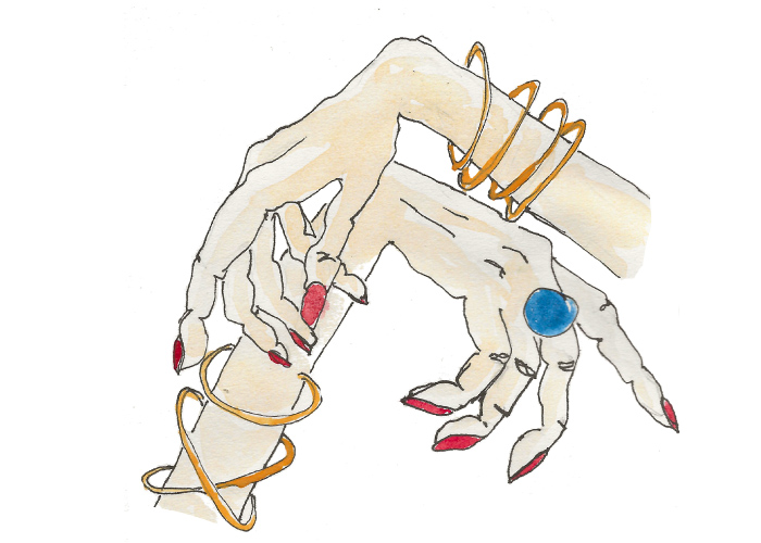 Mains avec des bracelets et des ongles très rouges